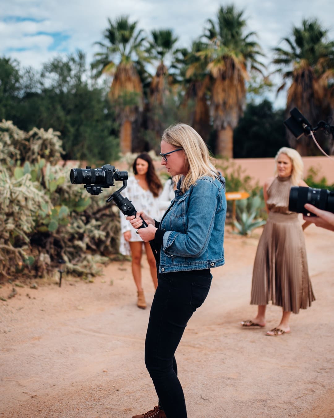 Videographer filming on a gimbal during a desert lifestyle shoot in Tucson